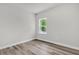 Clean and bright bedroom featuring wood-look floors and a window at 13971 Sw 46Th Ter, Ocala, FL 34473