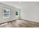 Bright, airy bedroom with wood-look flooring and two windows at 13971 Sw 46Th Ter, Ocala, FL 34473