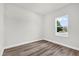 Minimalist bedroom with a view from the window and wood flooring at 13971 Sw 46Th Ter, Ocala, FL 34473