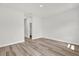 Neutral bedroom with wood-look floors and a walk-in closet at 13971 Sw 46Th Ter, Ocala, FL 34473