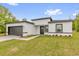 Attractive one-story house showcasing a fresh gray and white color scheme, landscaped yard, and attached garage at 13971 Sw 46Th Ter, Ocala, FL 34473