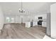 Open-concept kitchen with white cabinets, stainless steel appliances, and a center island with bar seating at 13971 Sw 46Th Ter, Ocala, FL 34473