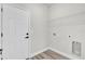 Clean laundry room with a white door, shelving and light wood flooring at 13971 Sw 46Th Ter, Ocala, FL 34473