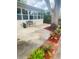 Relax on this patio with mature shade tree, bench, lush landscaping, and mulched flowerbeds at 1414 Meadowlark St, Longwood, FL 32750
