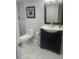 Stylish bathroom with marble floors, modern vanity, framed mirror and tiled shower at 1414 Meadowlark St, Longwood, FL 32750