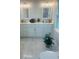Bright bathroom with double sinks, white cabinetry, marble floor, and decorative accents at 1414 Meadowlark St, Longwood, FL 32750