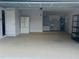 Spacious garage featuring ample storage space, utility sink, water heater, and additional refrigerator at 1414 Meadowlark St, Longwood, FL 32750