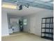 Large garage featuring storage shelves, utility sink, and water heater for added convenience at 1414 Meadowlark St, Longwood, FL 32750
