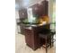 Eat-in kitchen with granite countertops, stone backsplash, stainless steel dishwasher and seating area at 1414 Meadowlark St, Longwood, FL 32750