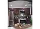 Modern kitchen with stainless steel appliances, dark wood cabinets, and decorative backsplash at 1414 Meadowlark St, Longwood, FL 32750
