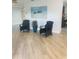 Spacious living room with stylish chairs, decor, and wood look tile flooring at 1414 Meadowlark St, Longwood, FL 32750