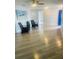 Open living room with light wood-look tile flooring, bright walls, and a blue front door at 1414 Meadowlark St, Longwood, FL 32750
