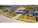 Aerial view of a beautifully landscaped home featuring a well-manicured lawn and brick driveway at 16018 Volterra Pt, Bella Collina, FL 34756