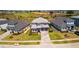 Aerial view of the property featuring lush landscaping, brick driveway, and mature trees at 16018 Volterra Pt, Bella Collina, FL 34756