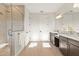 Bathroom with dual vanities, a large mirror, dark wood cabinets, and a stand alone shower with tile surround at 16018 Volterra Pt, Bella Collina, FL 34756