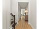 Light-filled hallway with wood floors leads to other areas of the home at 16018 Volterra Pt, Bella Collina, FL 34756