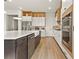 Well-equipped kitchen featuring an island with quartz countertop, and stainless steel appliances at 16018 Volterra Pt, Bella Collina, FL 34756