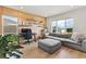 Comfortable living room with natural light, modern wood paneling, workspace, and sectional sofa at 16018 Volterra Pt, Bella Collina, FL 34756