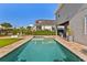Sparkling in-ground pool with patio, spa, and landscaping near covered outdoor dining at 16018 Volterra Pt, Bella Collina, FL 34756