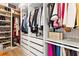Organized walk-in closet featuring custom shelves, drawers, and hanging rods to neatly store clothes and accessories at 16018 Volterra Pt, Bella Collina, FL 34756