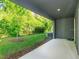Back porch with view of the manicured backyard at 1628 Little Wren Ln, Winter Park, FL 32792
