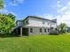 Beautifully kept lawn with covered patio, windows and grey and white exterior at 1628 Little Wren Ln, Winter Park, FL 32792
