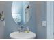 Half bath with vessel sink, and a modern mirror at 1628 Little Wren Ln, Winter Park, FL 32792