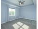 Spacious bedroom bathed in natural light features plush carpet, a ceiling fan, and large windows at 1628 Little Wren Ln, Winter Park, FL 32792