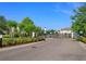 Community entrance with black metal gate and landscaping at 1628 Little Wren Ln, Winter Park, FL 32792