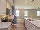 Bright, open kitchen with a granite island, stainless steel appliances, and white cabinets at 1628 Little Wren Ln, Winter Park, FL 32792