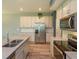 Bright, open kitchen with a granite island, stainless steel appliances, and white cabinets at 1628 Little Wren Ln, Winter Park, FL 32792