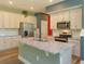 Bright, open kitchen with a granite island, stainless steel appliances, and white cabinets at 1628 Little Wren Ln, Winter Park, FL 32792