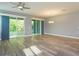 Spacious living room featuring hardwood floors, ceiling fan, and sliding glass doors for seamless indoor/outdoor living at 1628 Little Wren Ln, Winter Park, FL 32792