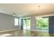 Spacious living room with hardwood floors, ceiling fan and sliding doors to outside area at 1628 Little Wren Ln, Winter Park, FL 32792