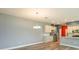 Spacious living room featuring hardwood floors and modern lighting with a view of the kitchen at 1628 Little Wren Ln, Winter Park, FL 32792