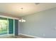 Spacious living room with a view of the screened patio through sliding doors featuring hardwood floors at 1628 Little Wren Ln, Winter Park, FL 32792