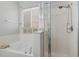 Clean bathroom with a glass shower, tub, and neutral decor creates a relaxing, spa-like ambiance at 16810 Sunrise Vista Dr, Clermont, FL 34714