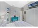 Cozy bedroom boasts seaside decor, a mounted TV and a comfortable, inviting atmosphere at 16810 Sunrise Vista Dr, Clermont, FL 34714