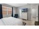 Comfortable bedroom features a TV, dresser, and a cozy sitting area with natural light at 16810 Sunrise Vista Dr, Clermont, FL 34714