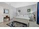 Elegant bedroom boasts a white bed, ornate accents, and a bright, welcoming ambiance at 16810 Sunrise Vista Dr, Clermont, FL 34714