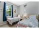 Charming bedroom featuring twin beds, colorful accents, and bright natural light creating a cheerful atmosphere at 16810 Sunrise Vista Dr, Clermont, FL 34714