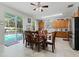 Bright dining area with a glass table, and stainless steel appliances, and access to the screened-in pool at 16810 Sunrise Vista Dr, Clermont, FL 34714