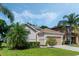 Charming single-story home with a well-manicured lawn and neutral-toned facade at 16810 Sunrise Vista Dr, Clermont, FL 34714