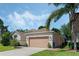 Well-maintained home featuring a two-car garage and a neatly landscaped front yard at 16810 Sunrise Vista Dr, Clermont, FL 34714