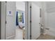 Hallway view to a bedroom and bath featuring neutral colors and tiled floors for a clean look at 16810 Sunrise Vista Dr, Clermont, FL 34714