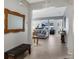 Welcoming hallway featuring neutral tile, a decorative mirror, and an open view to the living area at 16810 Sunrise Vista Dr, Clermont, FL 34714