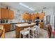 Bright kitchen features stainless appliances, wood cabinets and a center island with seating at 16810 Sunrise Vista Dr, Clermont, FL 34714