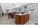 Bright kitchen area with a center island with seating, view of the breakfast table, and open access to living area at 16810 Sunrise Vista Dr, Clermont, FL 34714