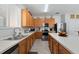 Large kitchen with abundant counter space, oak cabinets, stainless steel appliances, and tile flooring at 16810 Sunrise Vista Dr, Clermont, FL 34714