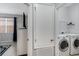 Well-lit laundry room featuring modern washer and dryer, ample storage space, and neutral tones at 16810 Sunrise Vista Dr, Clermont, FL 34714